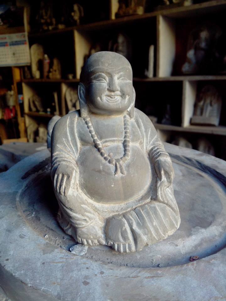 stone craving laughing buddha